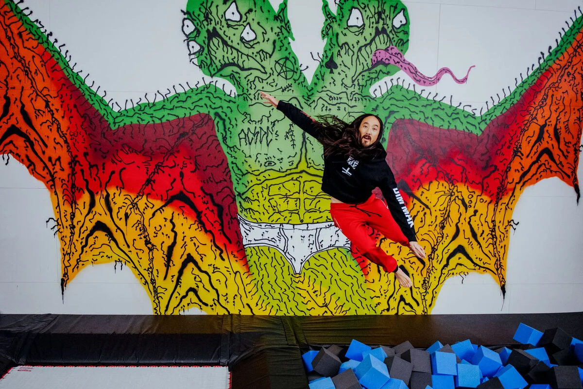 A custom mural by L.A.–based artist Neck Face overlooks “Aoki’s Playhouse,” a custom gym with a trampoline, a foam pit, and a rope swing. Photo by Brian Guido for Artsy.